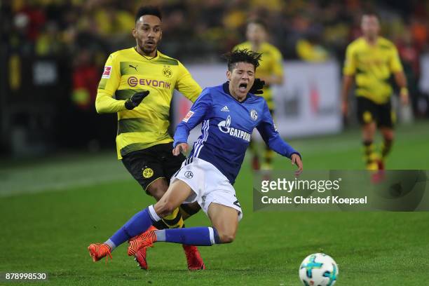 Amine Harit of Schalke is fouled by Pierre-Emerick Aubameyang of Dortmund which results in a red card during the Bundesliga match between Borussia...