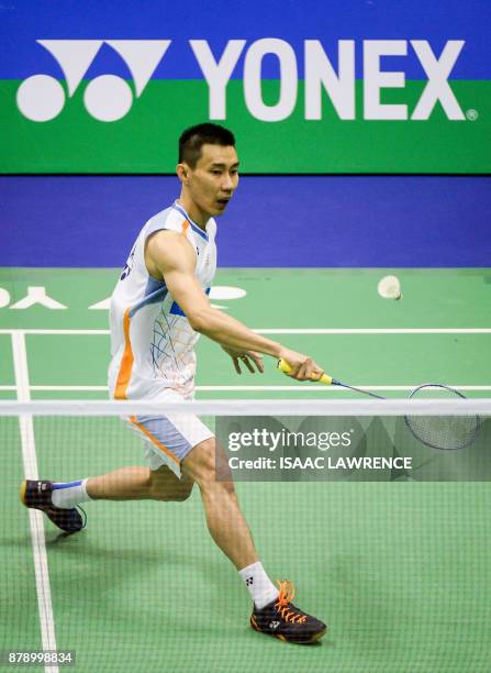 Malaysia's Lee Chong Wei hits a shot against China's Shi Yuqi during their men's singles semi-final match at the Hong Kong Open badminton tournament...