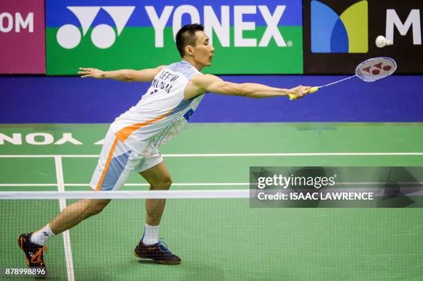 Malaysia's Lee Chong Wei hits a shot against China's Shi Yuqi during their men's singles semi-final match at the Hong Kong Open badminton tournament...