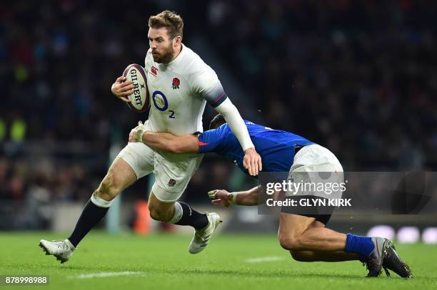 England's wing Elliot Daly is tackled by Samoa's wing Paul Perez during the autumn international rugby union test match between England and Samoa at...