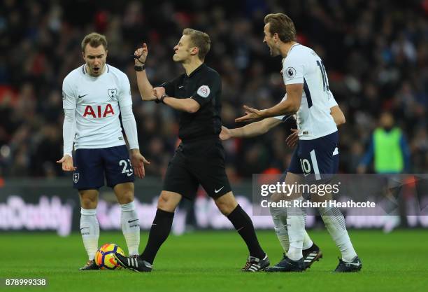 Christian Eriksen, Harry Winks and Harry Kane of Tottenham Hotspur appeal to match referee Mike Jones during the Premier League match between...