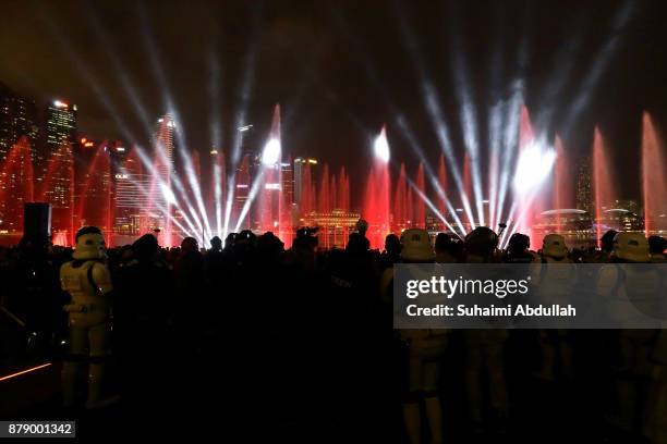 People watch the multimedia light and water show during the launch of the Marina Bay Sands Festive Light-Up - Star Wars:The Last Jedi Edition at...