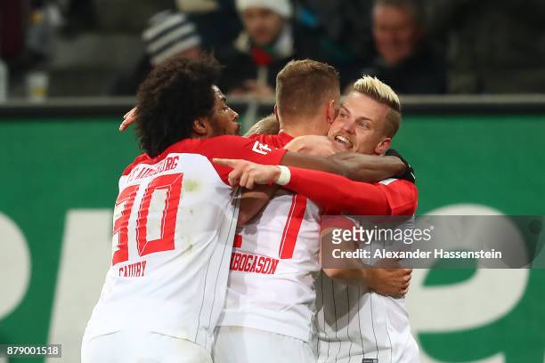 Caiuby of Augsburg, Alfred Finnbogason of Augsburg and Philipp Max of Augsburg) celebrate after Alfred Finnbogason of Augsburg scorned a goal to make...