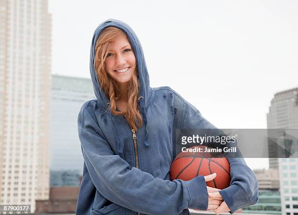 portrait of teenage girl with basketball - basketball teenager stock-fotos und bilder