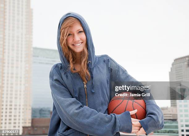 portrait of teenage girl with basketball - teenage girl basketball photos et images de collection