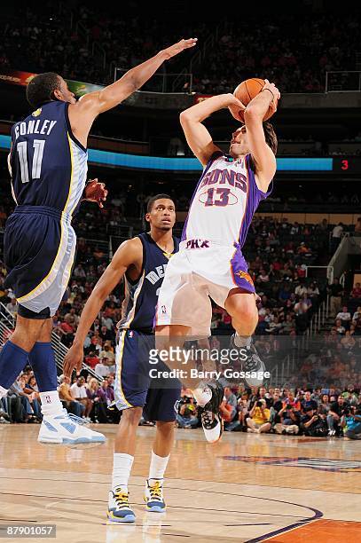 Steve Nash of the Phoenix Suns puts up a shot against Mike Conley and Rudy Gay of the Memphis Grizzlies during the game on April 13, 2009 at US...