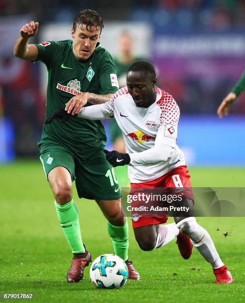 Max Kruse of Werder Bremen tackles Naby Keita of RB Leipzig during the Bundesliga match between RB Leipzig and SV Werder Bremen at Red Bull Arena on...