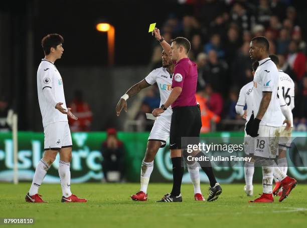 Ki Sung-Yueng of Swansea City is shown a yellow card during the Premier League match between Swansea City and AFC Bournemouth at Liberty Stadium on...