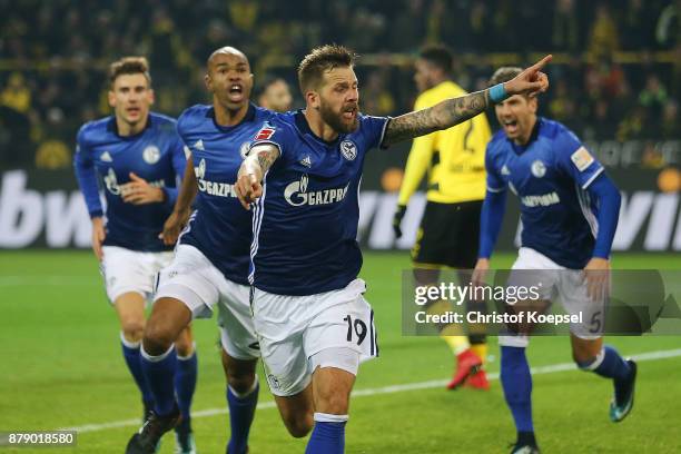 Guido Burgstaller of Schalke celebrates after Naldo of Schalke scored a goal to make it 4:4 during the Bundesliga match between Borussia Dortmund and...