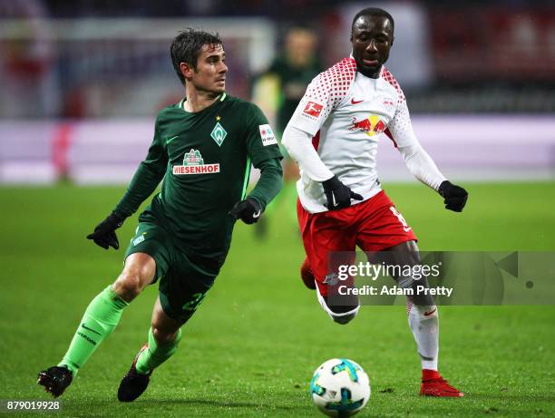 Fin Bartels of Werder Bremen is tackled by Naby Keita of RB Leipzig during the Bundesliga match between RB Leipzig and SV Werder Bremen at Red Bull...