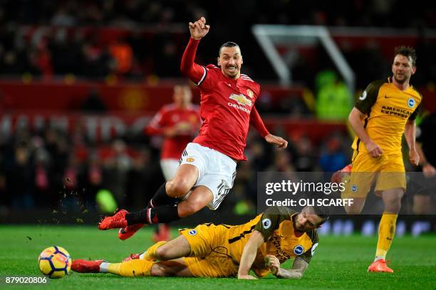 Brighton Irish defender Shane Duffy challenges Manchester United's Swedish striker Zlatan Ibrahimovic during the English Premier League football...