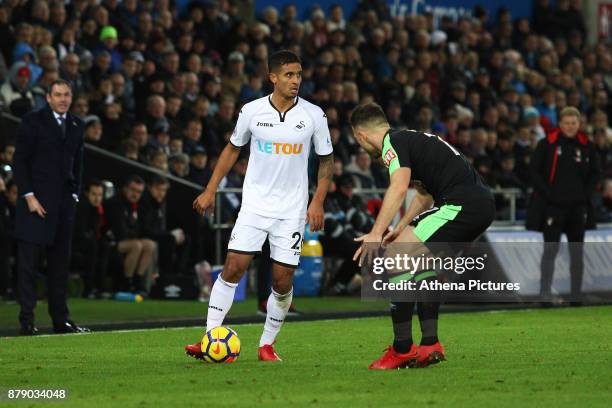 Swansea City manager Paul Clement and Bournemouth manager Eddie Howe watch on as Kyle Naughton of Swansea City is marked by Marc Pugh of Bournemouth...