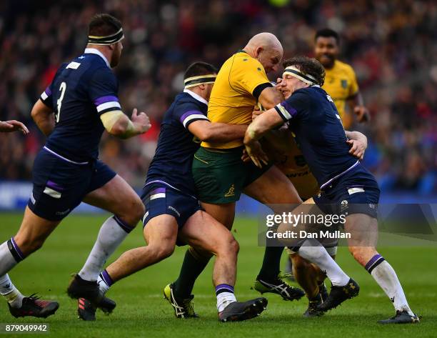 Stephen Moore of Australia is tackled by Stuart McInally of Scotland and Hamish Watson of Scotland during the International match between Scotland...