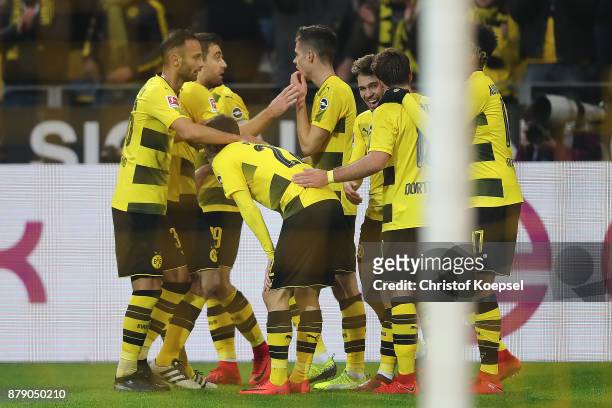 Raphael Guerreiro of Dortmund is celebrated by his team after he scored a goal to make it 4:0 during the Bundesliga match between Borussia Dortmund...