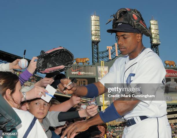 Curtis Granderson of the Detroit Tigers signs autographs before the game against the Oakland Athletics at Comerica Park on May 16, 2009 in Detroit,...