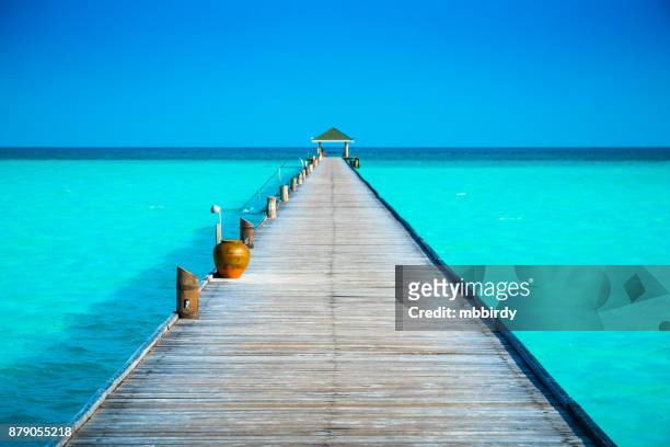 jetty at dhiffushi holiday island, south ari atoll, maldives - idyllic beach stock pictures, royalty-free photos & images