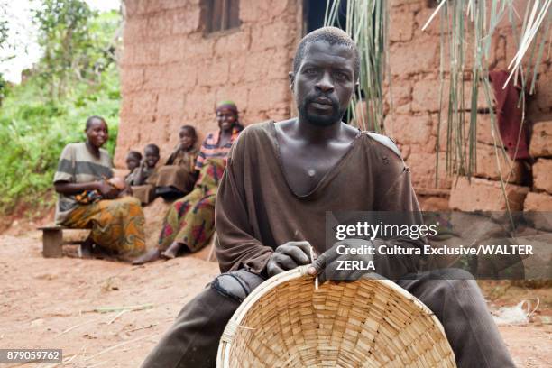 man basket weaving in village, masango, cibitoke, burundi, africa - burundi stock pictures, royalty-free photos & images