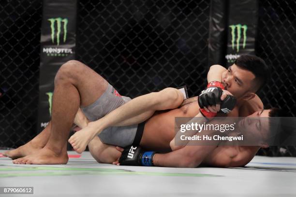Rolando Dy of Phillippines, up, fights with Wuliji Buren, down, during the UFC Fight Night at Mercedes-Benz Arena on November 25, 2017 in Shanghai,...