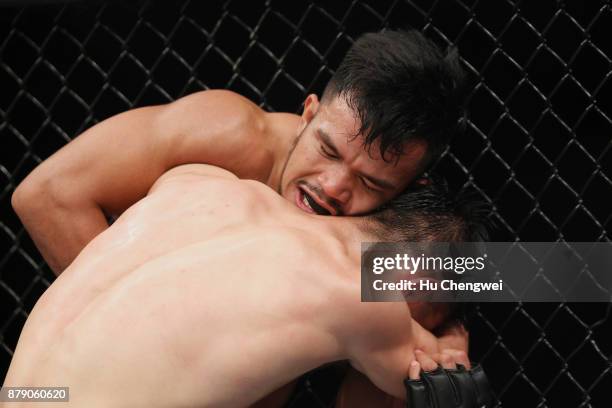 Rolando Dy of Phillippines fights with Wuliji Buren during the UFC Fight Night at Mercedes-Benz Arena on November 25, 2017 in Shanghai, China.
