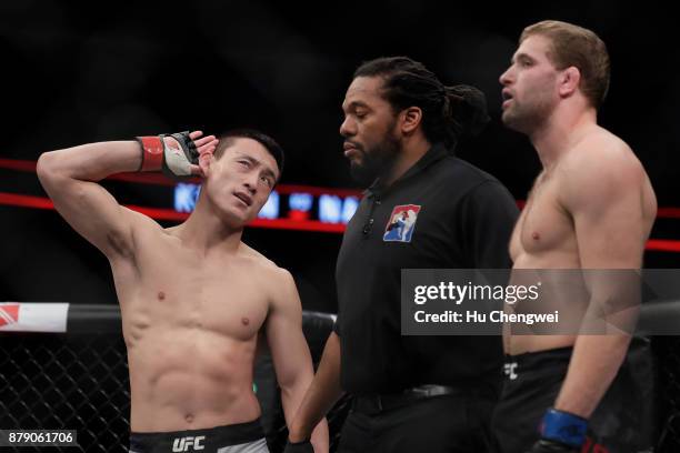 Song Kenan of China, left, gestures after his victory over Bobby Nash, right, during the UFC Fight Night at Mercedes-Benz Arena on November 25, 2017...
