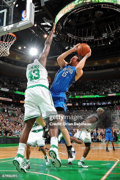 Hedo Turkoglu of the Orlando Magic goes up for a shot against Kendrick Perkins of the Boston Celtics in Game Five of the Eastern Conference...