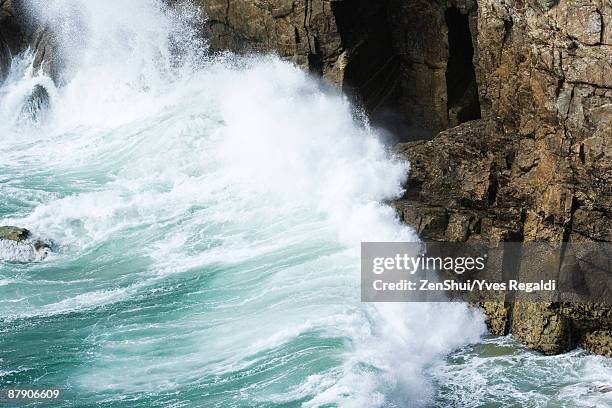 waves crashing against cliff side, close-up - waves crashing on rocks stock pictures, royalty-free photos & images