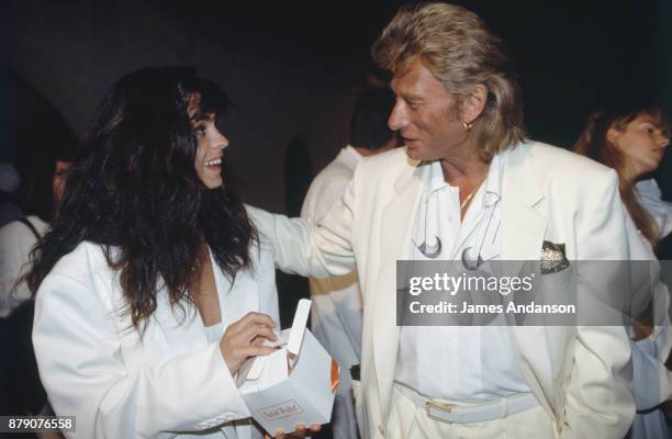 Ramatuelle, French singer Johnny Hallyday and his wife Adeline at Eddie Barclay's reception, 27th July 1991