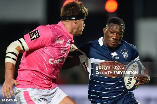 Agen's Yoan Tanga-Mangene runs with the ball during the French Top 14 rugby union match between SU Agen and Stade Francais on November 25, 2017 at...