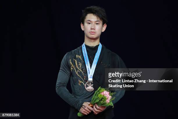 Bronze medalist Denis Ten of Kazakhstan looks on in the victory ceremony for men free skating during the 2017 Shanghai Trophy at the Oriental Sports...