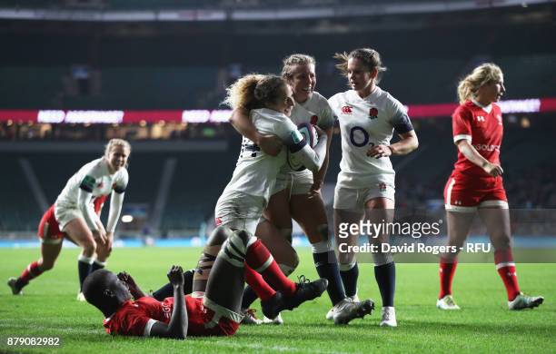 Abigail Dow of England celebrates scoring his sides thrid try with her team mates during the Old Mutual Wealth Series match between England and...