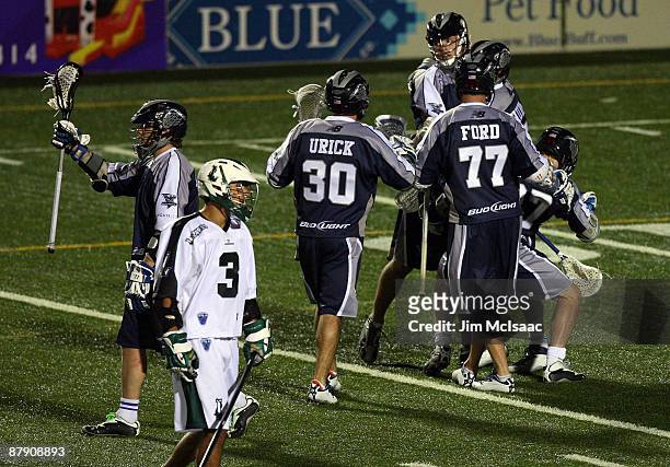 The Washington Bayhawks celebrate their overtime victory as Ricky Pages of the Long Island Lizards looks on during their Major League Lacrosse game...