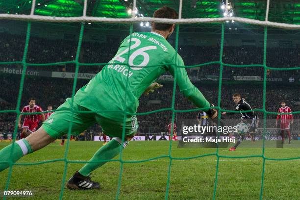 Thorgan Hazard of Moenchengladbach about to take a penally past Sven Ulreich of Bayern Muenchen that results in a goal to make it 1:0 during the...