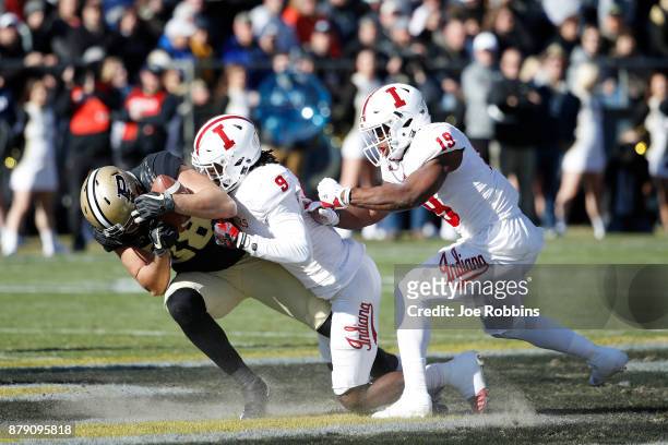 Jonathan Crawford and Tony Fields of the Indiana Hoosiers tackle Brycen Hopkins of the Purdue Boilermakers in the first quarter of a game at Ross-Ade...