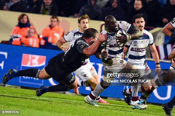 Bordeaux-Begles' French flanker Mahamadou Diaby is tackled during the French Top 14 rugby union match between Bordeaux-Begles and Brive on November...