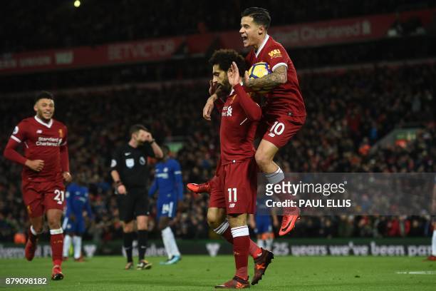 Liverpool's Egyptian midfielder Mohamed Salah reacts with Liverpool's Brazilian midfielder Philippe Coutinho after scoring the opening goal of the...