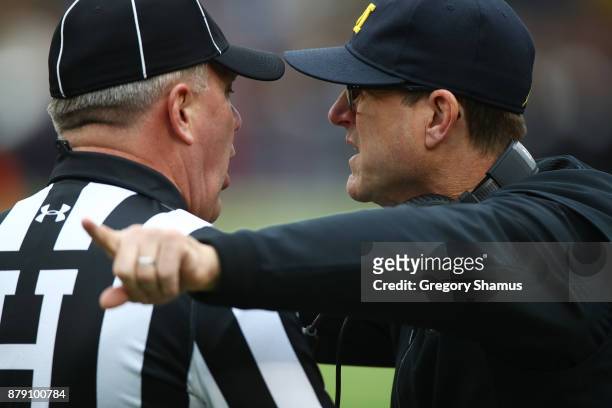 Jim Harbaugh head coach of the Michigan Wolverines talks with the referee first half against the Ohio State Buckeyes on November 25, 2017 at Michigan...