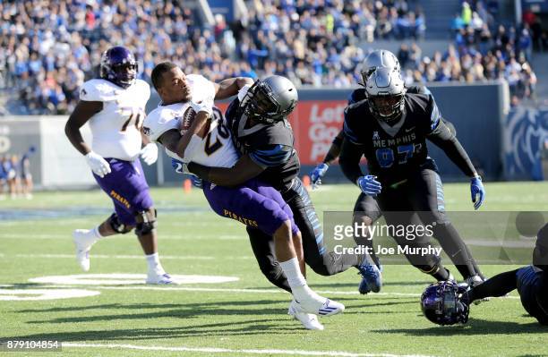 Devin Anderson of the East Carolina Pirates is tackled by La'Andre Thomas of the Memphis Tigers on November 25, 2017 at Liberty Bowl Memorial Stadium...