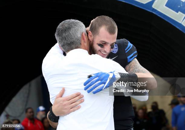 Mike Norvell, head coach of the Memphis Tigers hugs Riley Ferguson of the Memphis Tigers during Senior Day festivities before the game against the...