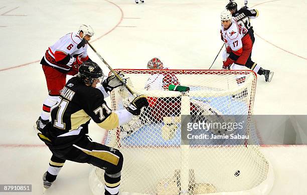 Goaltender Cam Ward and Tim Gleason of the Carolina Hurricanes look back after Evgeni Malkin of the Pittsburgh Penguins scores a goal during Game Two...
