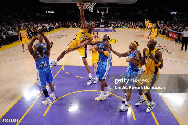 Trevor Ariza of the Los Angeles Lakers dunks the ball against Dahntay Jones and Nene of the Denver Nuggets in the third quarter of Game Two of the...