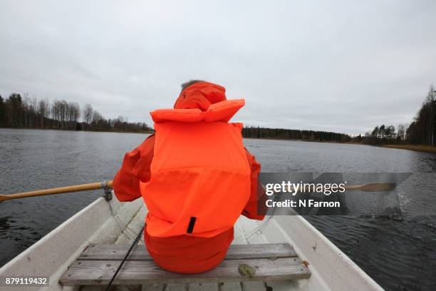 man in orange jacket rowing - n farnon stock pictures, royalty-free photos & images