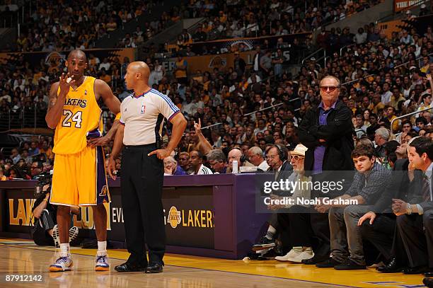 Kobe Bryant of the Los Angeles Lakers argues a call while actor Jack Nicholson looks on in the fourth quarter against the Denver Nuggets in Game Two...