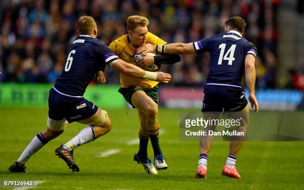 Reece Hodge of Australia is tackled by John Barclay of Scotland and Tommy Seymour of Scotland during the international match between Scotland and...