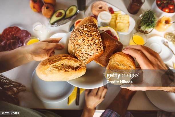 frühstückstisch mit teller mit brötchen - breakfast time stock-fotos und bilder