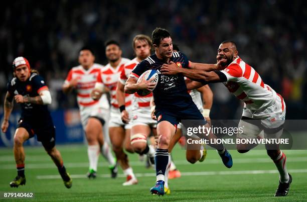 Japan's flanker and captain Michael Leitch tackles France's centre Henry Chavancy during the friendly rugby union international Test match between...