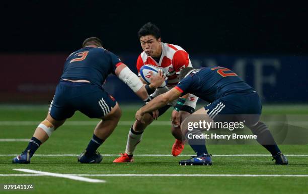 Harumichi Tatekawa of Japan tackled by Rabah Slimani and Guilhem Guirado of France during the international rugby union match between France and...