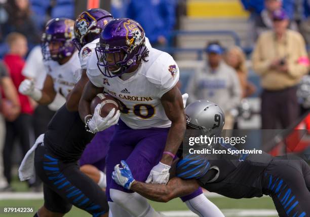 Memphis wide receiver John "Pop" Williams wraps up ECU wide receiver Trevon Brown as he tries to run back the opening kick-off of the college...