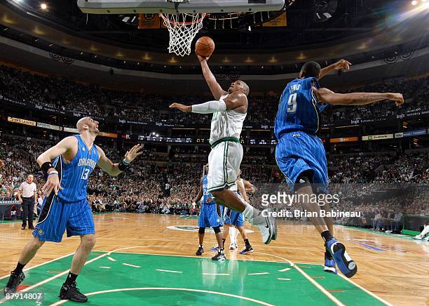 Glen Davis of the Boston Celtics shoots a layup against Marcin Gortat and Rashard Lewis of the Orlando Magic in Game Five of the Eastern Conference...