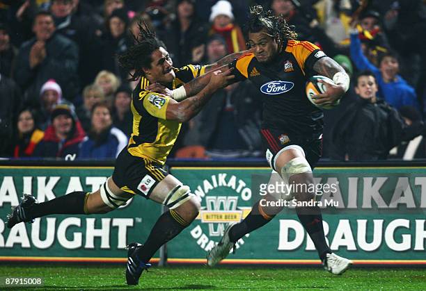 Sione Lauaki of the Chiefs fends off Rodney So'oialo of the Hurricanes during the first semi final Super 14 match between the Chiefs and the...