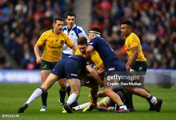 Sean McMahon of Australia is tackled by Hamish Watson and Stuart McInally of Scotland during the International match between Scotland and Australia...